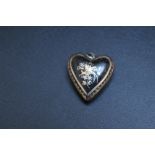 AN INLAID HEART SHAPED MOURNING PENDANT, possibly tortoiseshell and decorated with a tropical