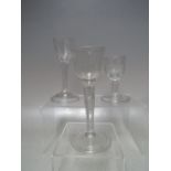 A SELECTION OF THREE GEORGIAN DRINKING GLASSES, to include two plain stem examples with textured /