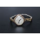A LADIES 9CT GOLD CASED VINTAGE ROLEX WRISTWATCH, on expanding base metal bracelet, the face stamped