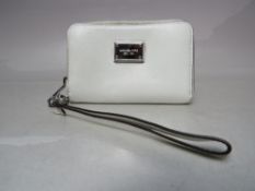 A SMALL MICHAEL KORS WINTER WHITE PURSE, complete with wrist strap, single zip closure, multiple