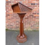 A GOTHIC OAK LECTERN, raised on an octagonal base, with angled support leading to a sloped