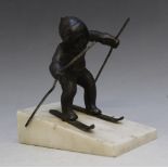 A VINTAGE BRONZE MODEL OF A SKIER, on a marble 'ski slope', H 12 cm