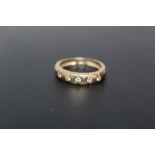 A YELLOW METAL GEMSET ETERNITY TYPE RING, indistinct marks- not tested fro gold, gems do not test as