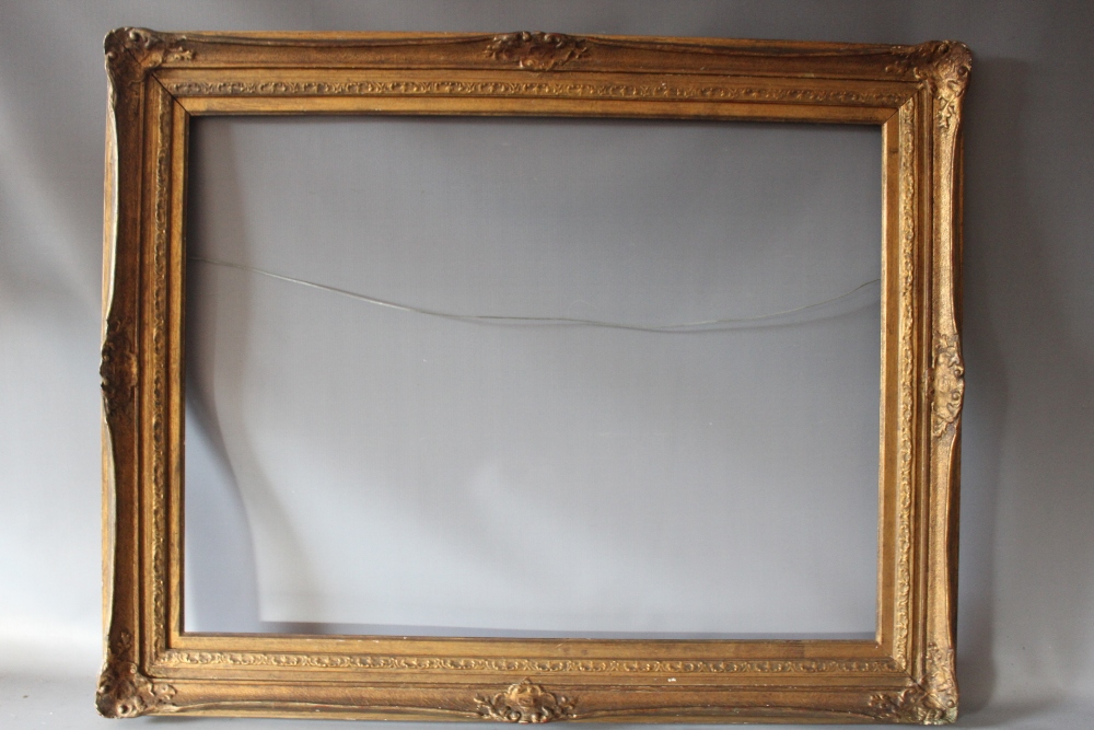 AN EARLY 20TH CENTURY GOLD SWEPT FRAME, with gold slip, frame W 8 cm, slip rebate 88 x 66 cm,