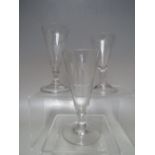 A SELECTION OF THREE 18TH CENTURY GEORGIAN ENGRAVED TRUMPET BOWL ALE & WINE GLASSES, the tallest wit