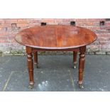 A 19TH CENTURY MAHOGANY PULL-OUT EXTENDING DINING TABLE, with one extra leaf, raised on turned