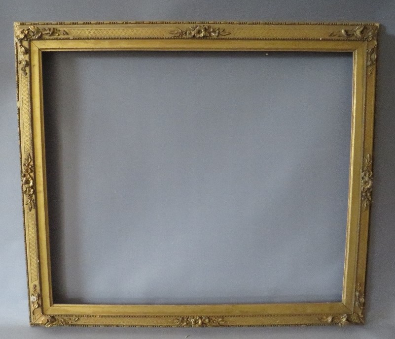 A 19TH CENTURY DECORATIVE GOLD WATERCOLOUR FRAME, with integral gold slip (some damages), frame W