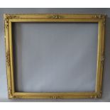 A 19TH CENTURY DECORATIVE GOLD WATERCOLOUR FRAME, with integral gold slip (some damages), frame W