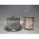 A SILVER PLATED AND CERAMIC BISCUIT BARREL AND COVER, the ribbed effect ceramic barrel with