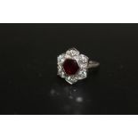 A HALLMARKED 18 CARAT WHITE GOLD RUBY AND DIAMOND RING, set with six brilliant cut diamonds and a