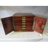 A MID VICTORIAN MAHOGANY TABLE TOP COLLECTORS CABINET, having twin doors opening to a range of six