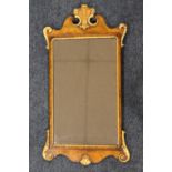 A 20TH CENTURY GEORGIAN STYLE WALNUT PIER MIRROR, having carved detailing outlined in gilt, Prince