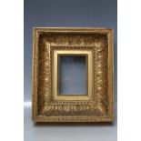 A LATE 18TH / EARLY 19TH CENTURY DECORATIVE GOLD FRAME, with acanthus leaf design and integral