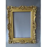 A 19TH CENTURY CARVED WOODEN GILT SWEPT AND PIERCED FRAME, with integral slip, frame W 7.5 cm,