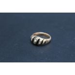 A 15 CT SEED PEARL AND ENAMEL MOURNING RING, with integral keepsake area to the inner band, approx