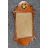 A 19TH CENTURY WALNUT PIER MIRROR OF TYPICAL SHAPED OUTLINE, with a gilt pierced plume of