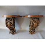 A PAIR OF NINETEENTH CARVED OAK WALL BRACKETS, both brackets with Rococo scrolling, later shelves, H