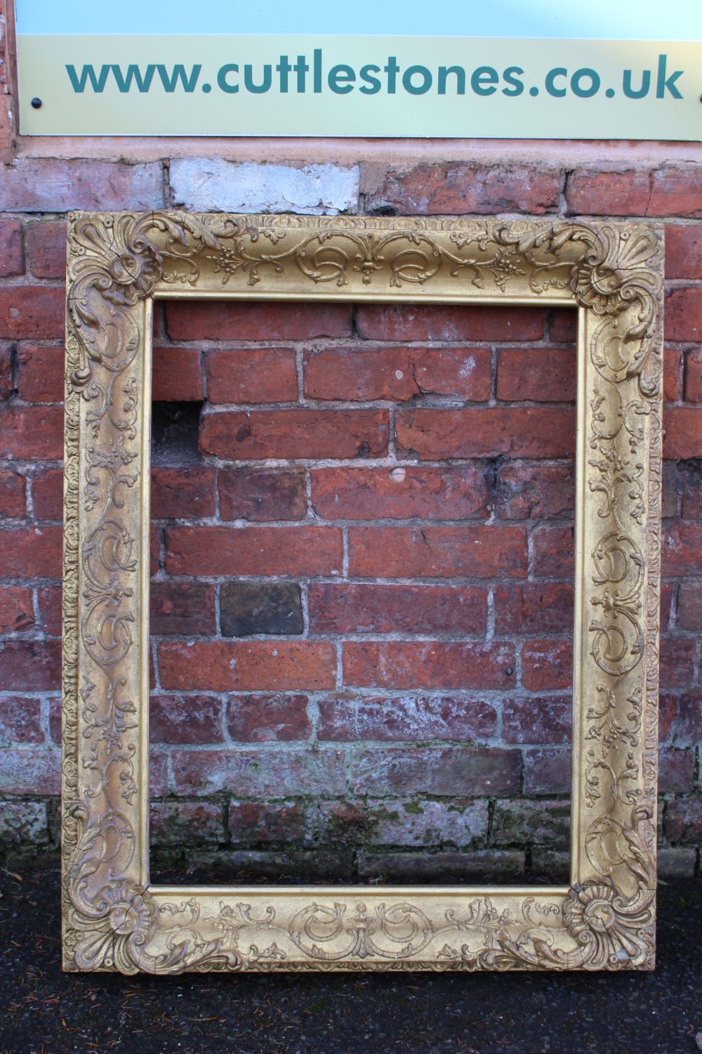 A 19TH CENTURY DECORATIVE GOLD FRAME WITH CORNER EMBELLISHMENTS, and design to corner edge, frame