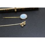 A 9CT STICK PIN WITH WISHBONE SET WITH SEED PEARL AND BLUE TOPAZ TYPE STONE, together with an