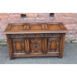 A 20TH CENTURY CARVED OAK SMALL TRIPLE PANEL COFFER, H 58 cm, W 106 cm, D 46 cm