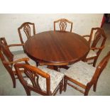 A SOLID PINE EXTENDING DUCAL DINING TABLE AND SIX CHAIRS