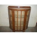 A BOW FRONTED CHINA DISPLAY CABINET