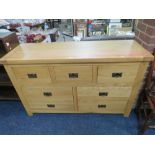 A MODERN OAK SEVEN DRAWER MULTI CHEST W-140 CM