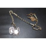 A VINTAGE WHITE METAL POCKET WATCH CHAIN MOUNTED WITH FOBS AND KEYS
