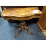 A MID VICTORIAN WALNUT SHAPED FOLD-OVER CARD TABLE ON CARVED SUPPORTS W-91 CM