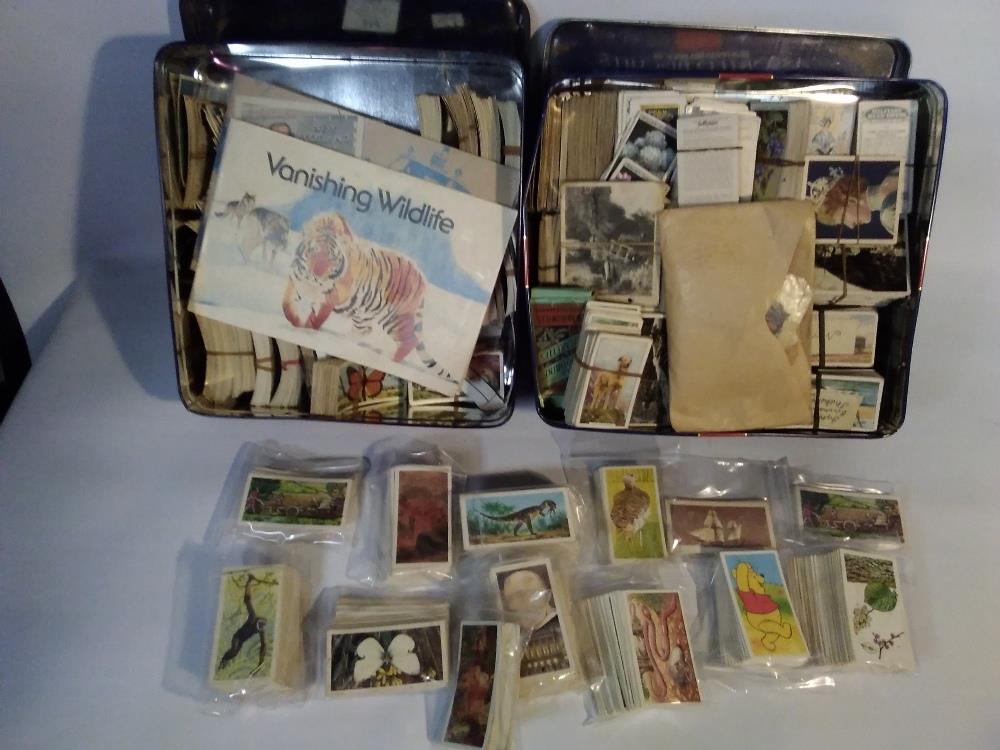 THREE TINS OF ASSORTED TEA AND CIGARETTE CARDS, LOOSE AND IN SLOTS