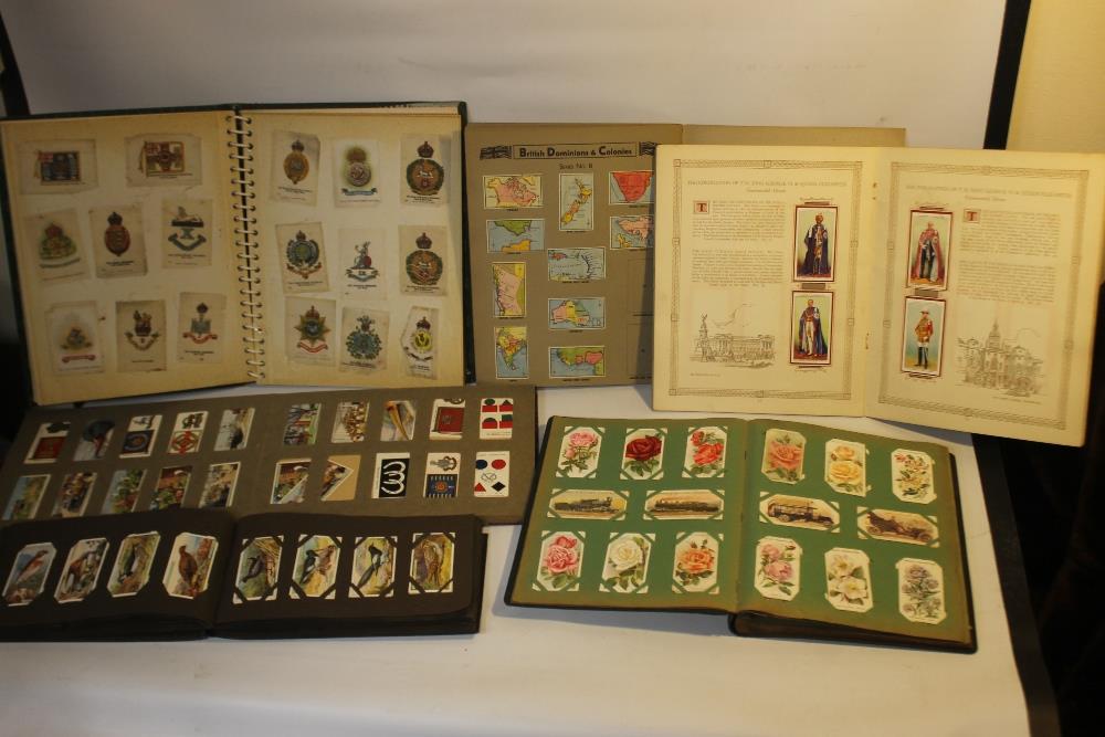 A COLLECTION OF CIGARETTE CARDS IN VARIOUS ALBUMS, to include a small quantity of silks of British