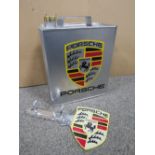 A PORSCHE OIL CAN AND KEY HOLDER