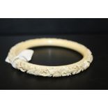 AN ANTIQUE CARVED IVORY BANGLE, internal Dia. 8.1 cmConditon Report:Approx 38.8 g