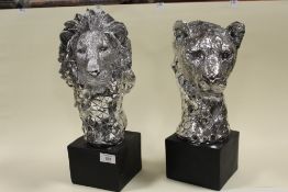 TWO MODERN DECORATIVE SILVER RESIN LION AND LIONESS BUSTS ON PLINTHS