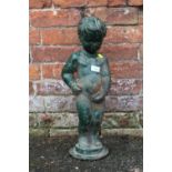 A VINTAGE CAST IRON FIGURE OF A YOUNG BOY