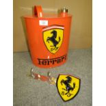 A FERRARI OIL CAN AND KEY HOLDER