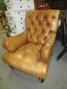 A VINTAGE TAN LEATHER BUTTON BACKED ARMCHAIR - A/F