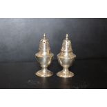 A PAIR OF SMALL HONG KONG SILVER PEPPERETTES