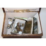A VINTAGE OAK LIDDED BOX CONTAINING VINTAGE COINS NOTES AND WRIST WATCHES