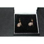A PAIR OF 9CT GOLD AND DIAMOND EARRINGS