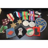 A VINTAGE OXO TIN CONTAINING WWII MEDALS TO INCLUDE AN AFRICA STAR EXAMPLE, PATCHES