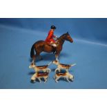 A BESWICK HUNTSMAN ON BROWN HORSE AND FOUR BESWICK HOUNDS