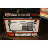 A BOXED PRINZ MAGNON DUO ZOOM PROJECTOR TOGETHER WITH A BOX OF PROJECTOR FILMS