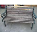 A CAST IRON AND WOOD GARDEN BENCH