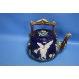 A 19TH CENTURY MAJOLICA TEAPOT DECORATED WITH A WHITE BIRD AND BULLRUSHES