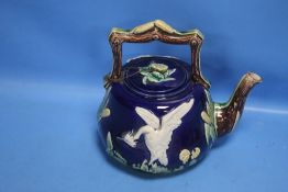 A 19TH CENTURY MAJOLICA TEAPOT DECORATED WITH A WHITE BIRD AND BULLRUSHES