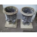 A PAIR OF CONCRETE PLANTERS AND PLINTHS