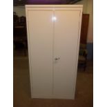 A STRONG STEEL TWO DOOR SHELVED STORAGE CABINET