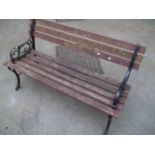 A CAST IRON AND WOODEN GARDEN BENCH