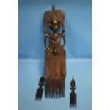 A LARGE AND TWO SMALL WOODEN TRIBAL COMBS